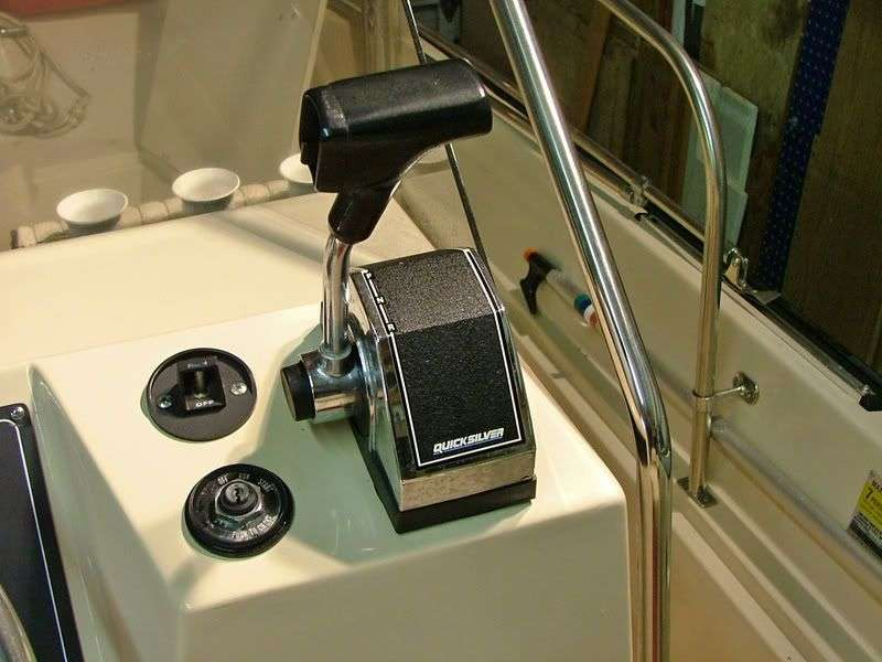 Traditional mechanical Mercury throttle and shift control with cables routed at boat helm