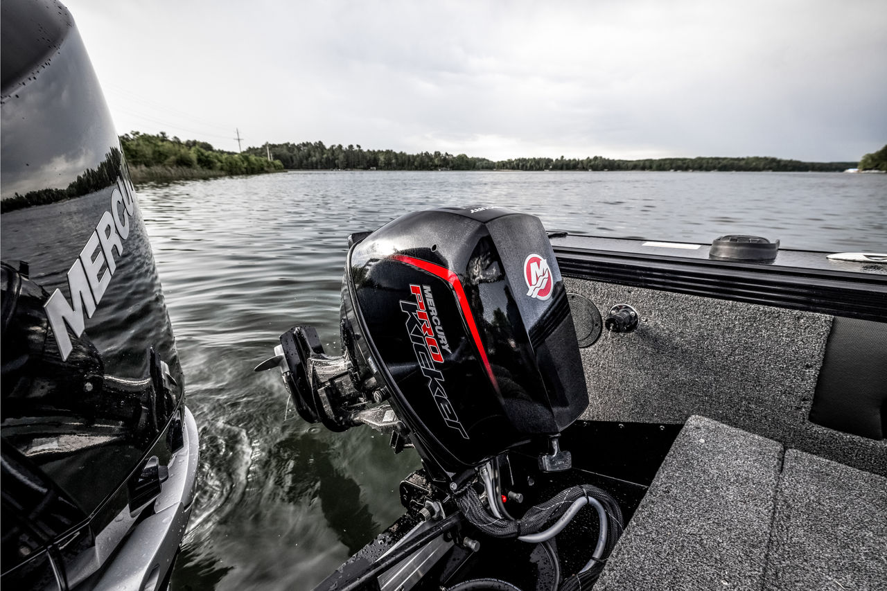 Mercury 9.9 EFI ProKicker kicker alongside main outboard on fishing boat transom