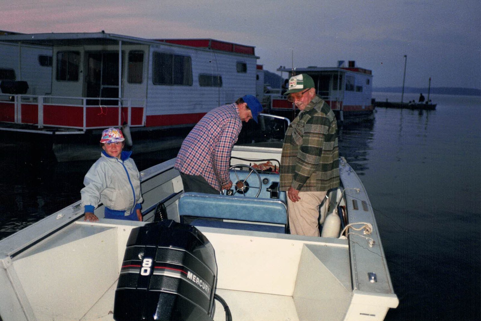 George Harris (right), his son Jim (centre), and grandson Jay heading out from the Harris Boat Works docks, 1988. The motor on the transom is a Mercury 80.
